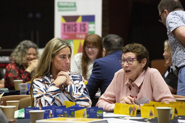 Two delegates in conversation at the 2025 convention