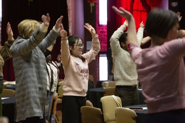 Delegates with hands raised during a session